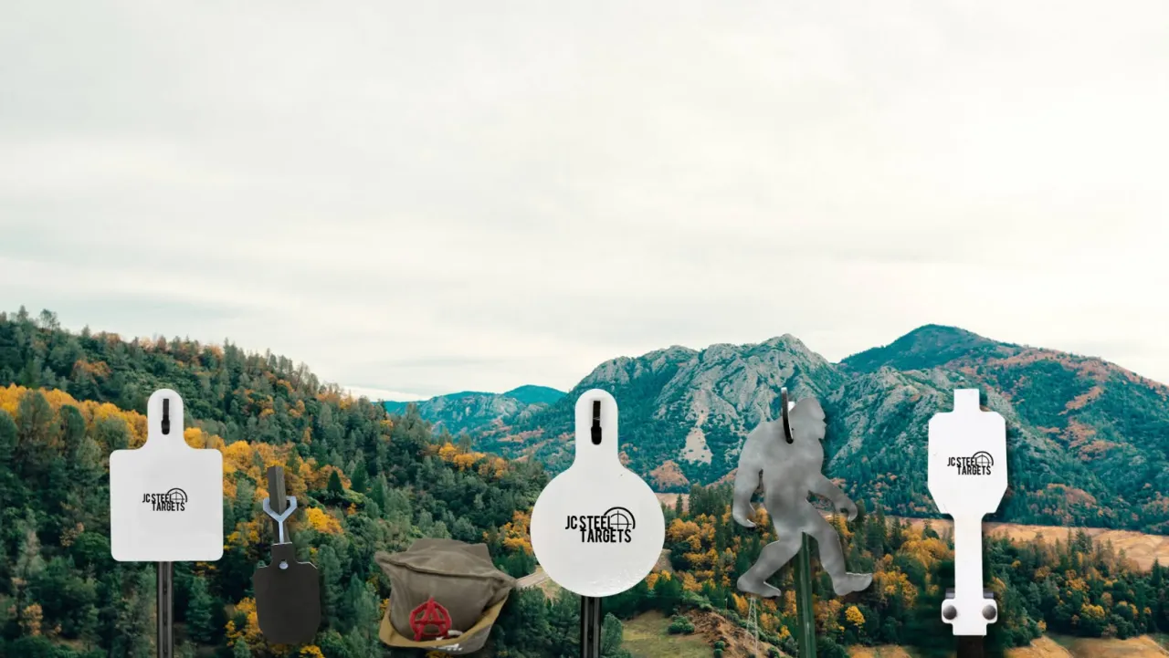 Assortment of JC Steel Targets steel targets displayed in front of autumn mountains