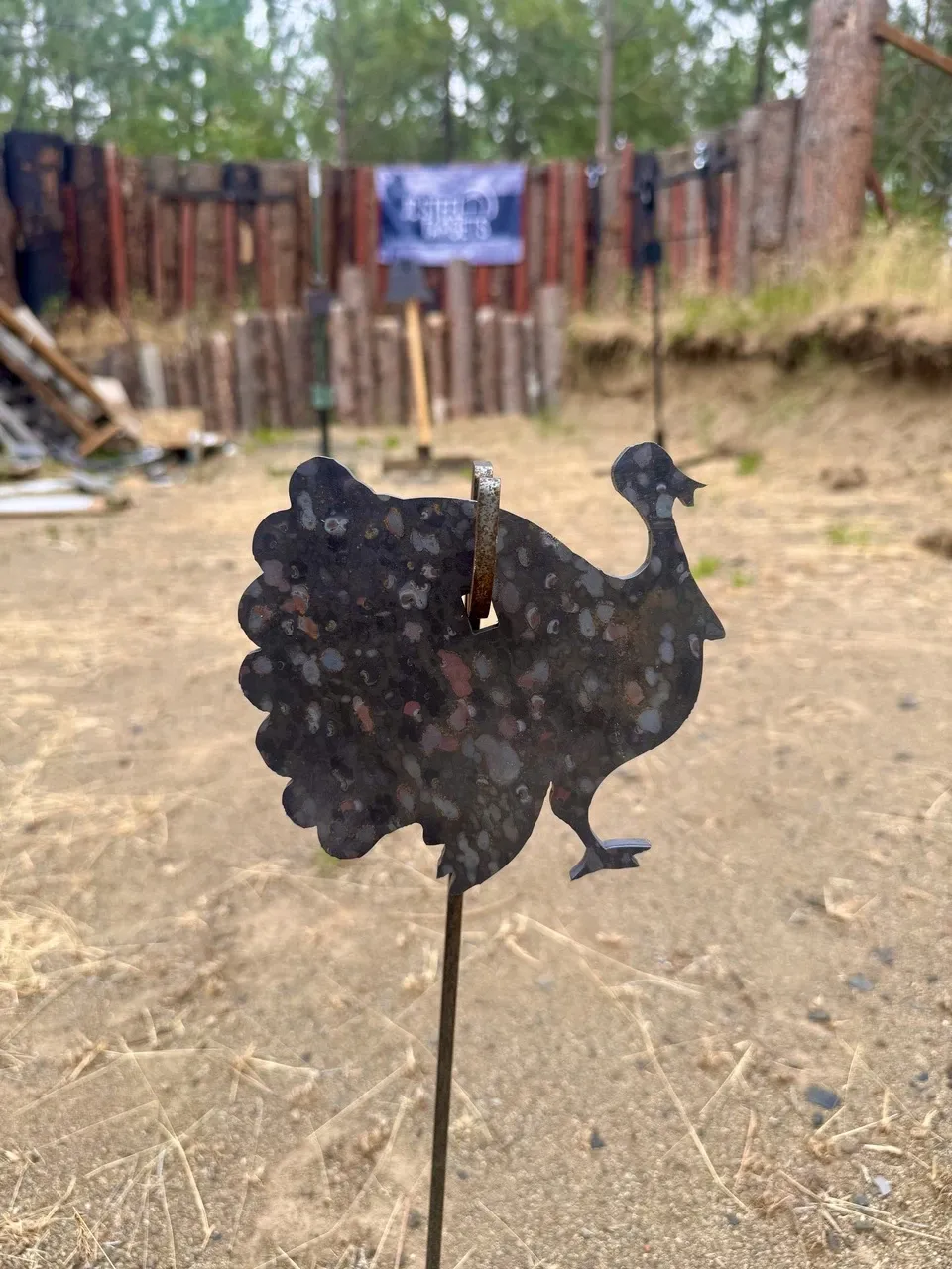 Turkey-shaped steel target on a stand at an outdoor range