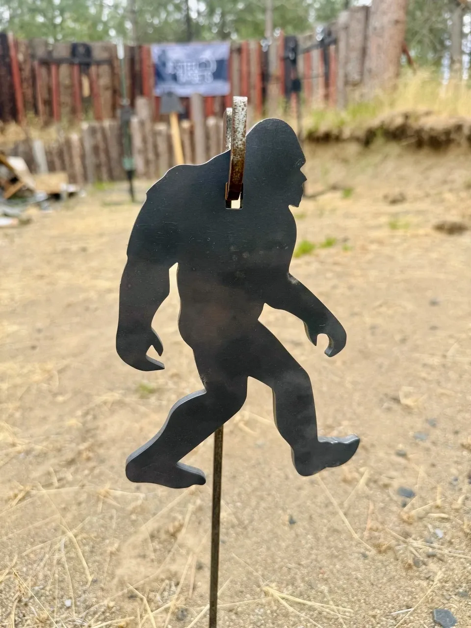 Bigfoot-shaped steel target on a stand at an outdoor range