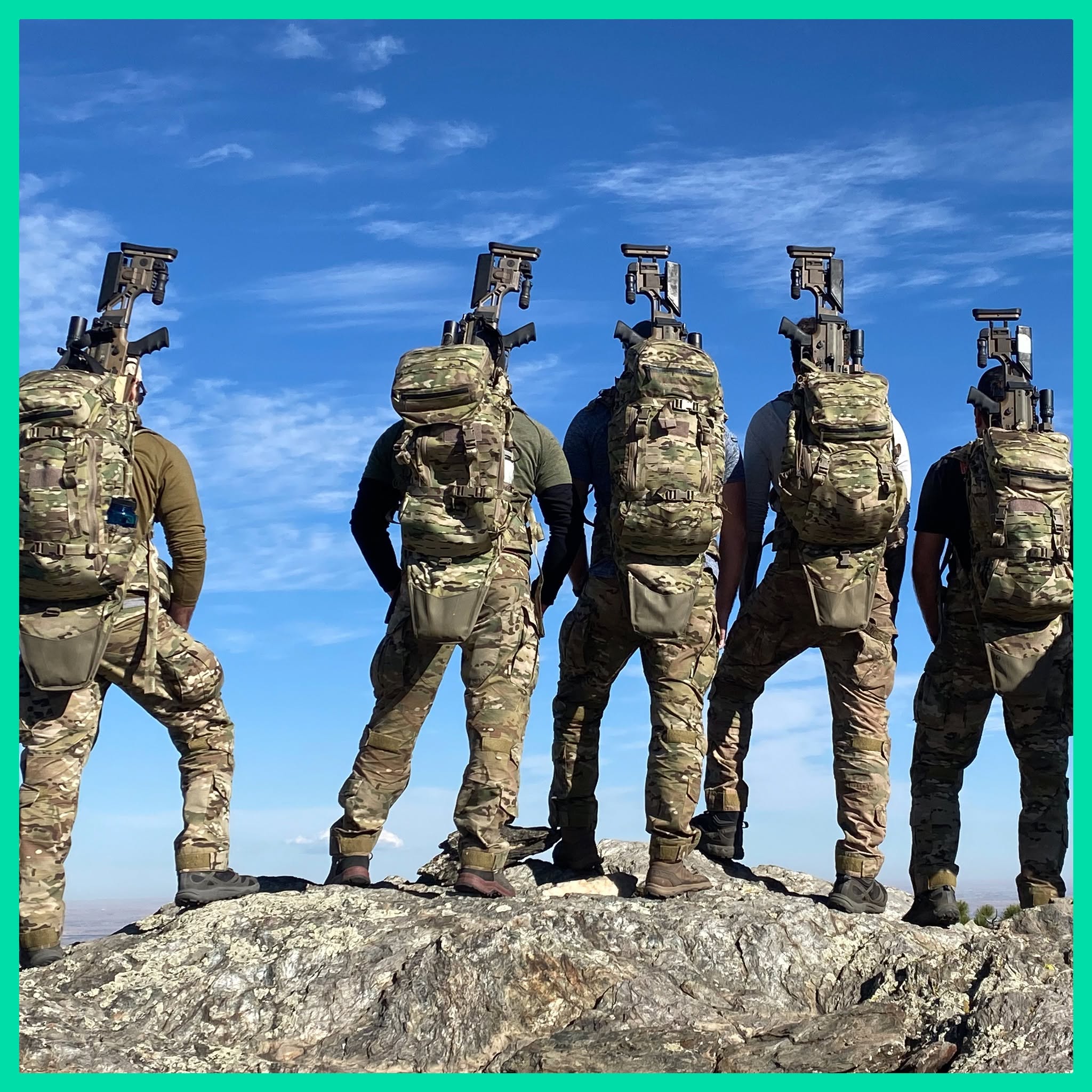 A tactical team scanning the valley below from a scenic mountain summit